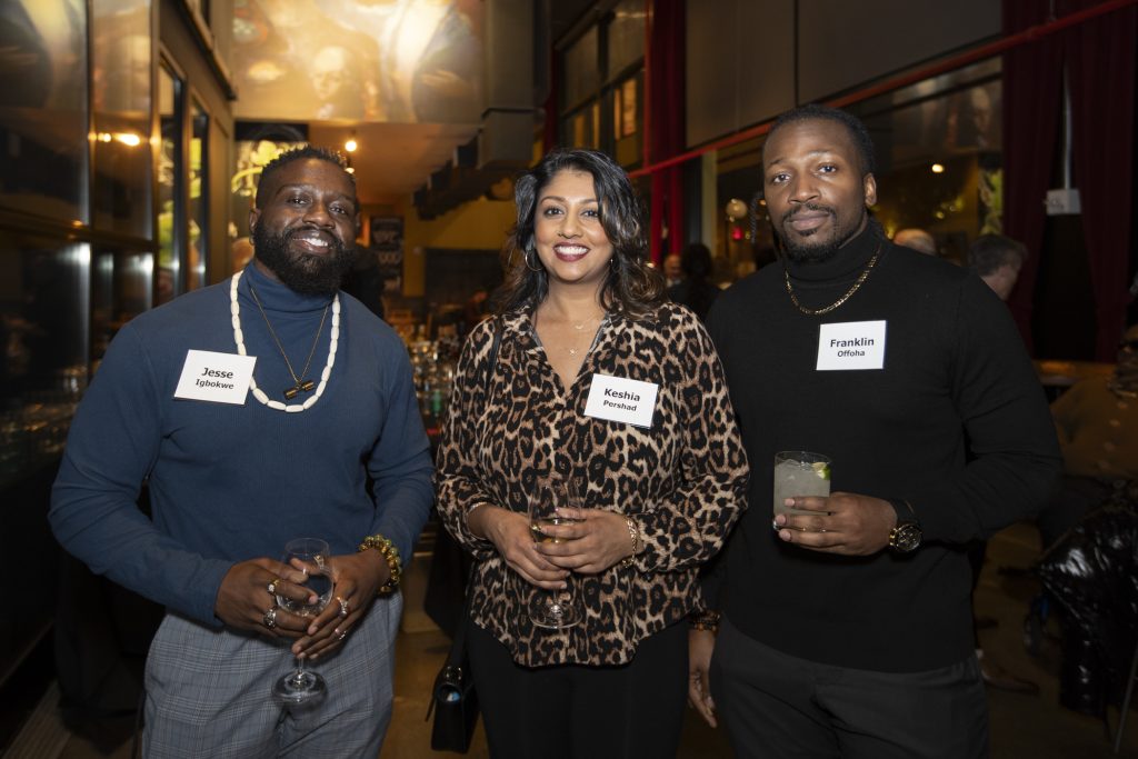 Three guests posing and smiling