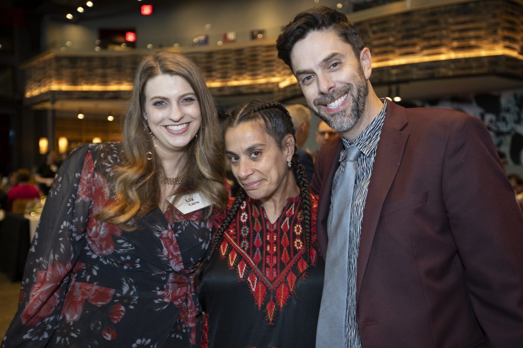 Three guests posing and smiling