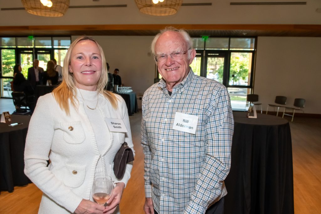 DRA Advisor Bill Alderman smiling with an event guest