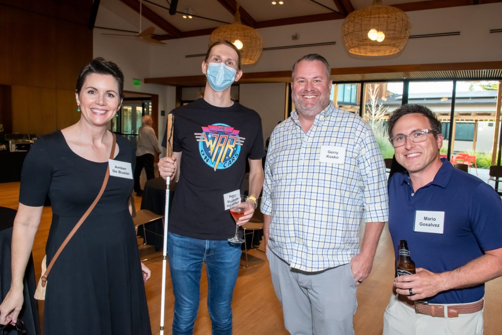 Four event guests smiling and posing together