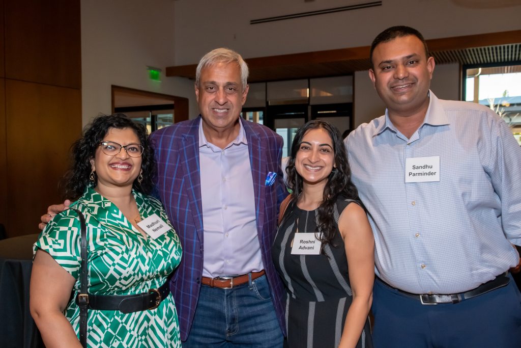 Honoree Neel Chatterjee smiling with three event guests