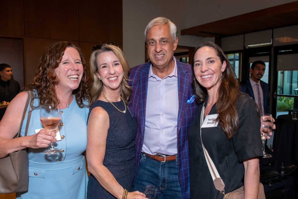 Honoree Neel Chatterjee smiling with three event guests