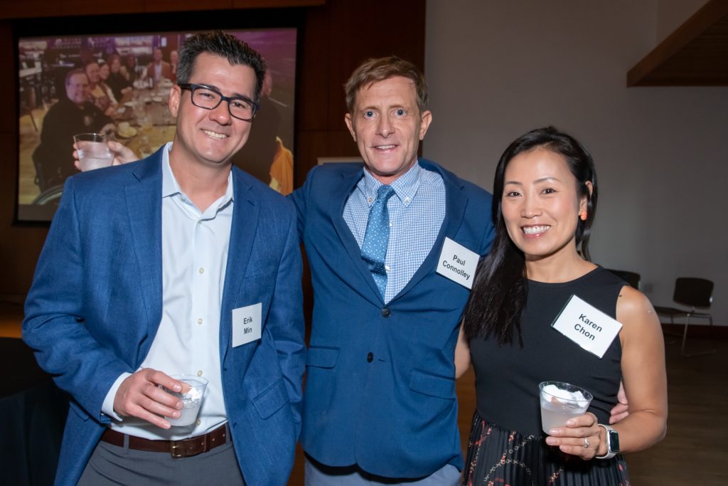 Three event guests smiling together