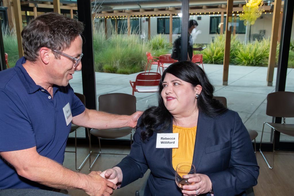 DRA's Rebecca Williford shaking hands with an event guest