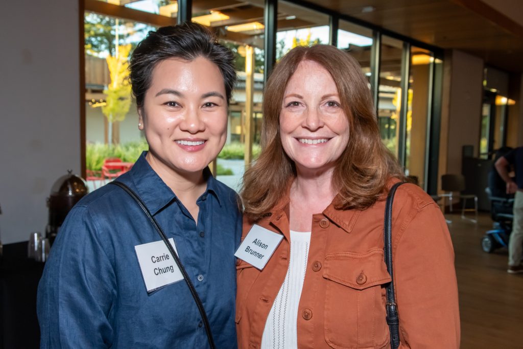 Two event guests smiling together