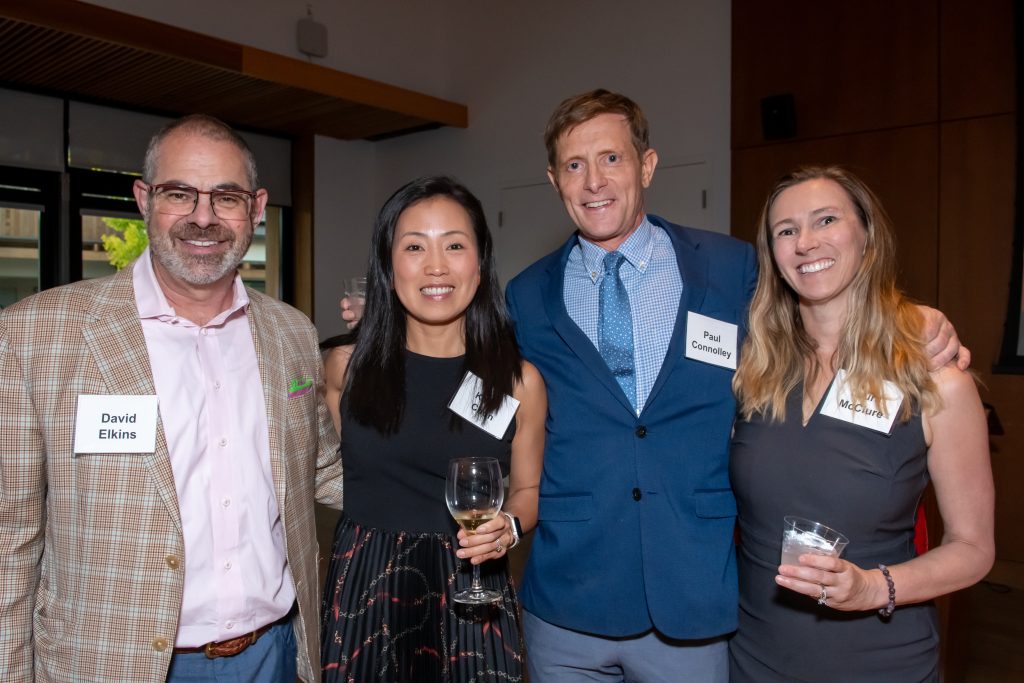 Four event guests smiling together