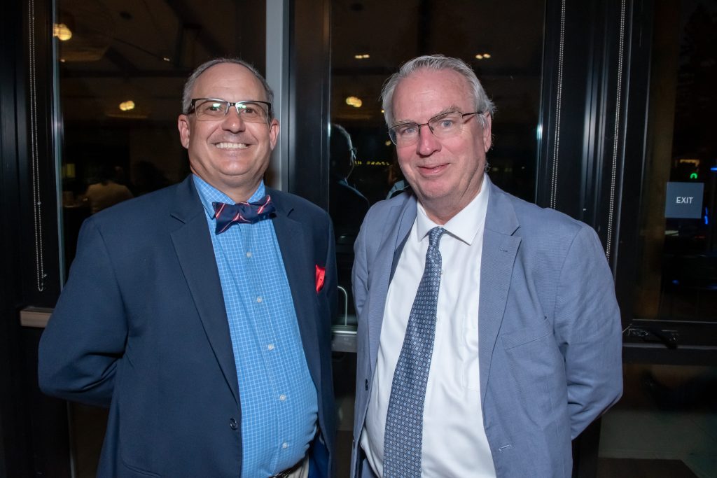 Two event guests smiling together