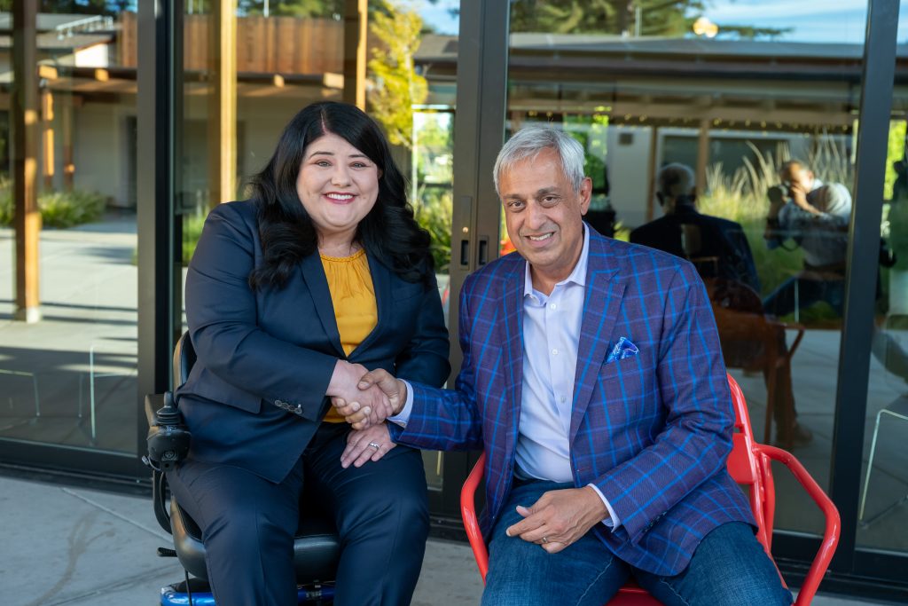 DRA's Rebecca Williford and Honoree Neel Chatterjee smiling and shaking hands